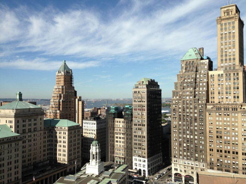 Skyline of Brooklyn, NY featuring iconic historic skyscrapers against a clear sky.